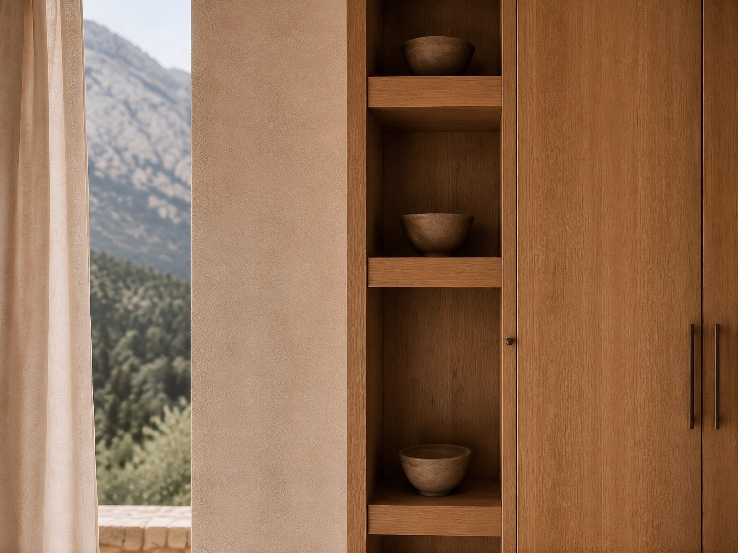 Built-in wooden wardrobe with open shelves displaying rustic bowls, next to a window with a mountain view.